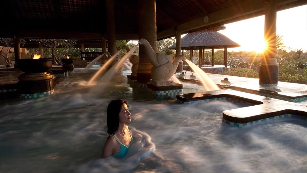 a women enjoying the pool water at bali resort